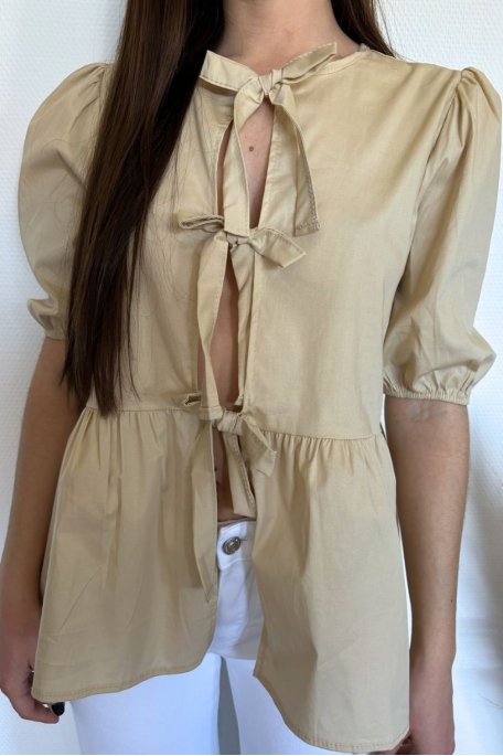Short-sleeved beige blouse with bows